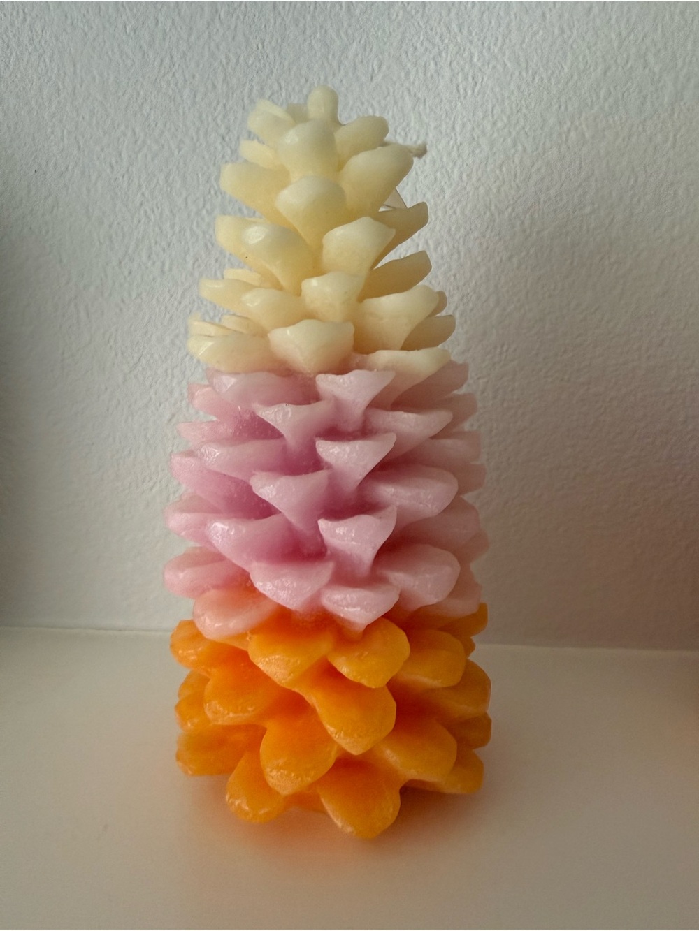 Anthropologie ombre pinecone decorative candle in cream, pink, orange
